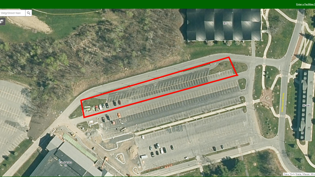 Aerial shot of parking lot, with one section outlined in red markings.