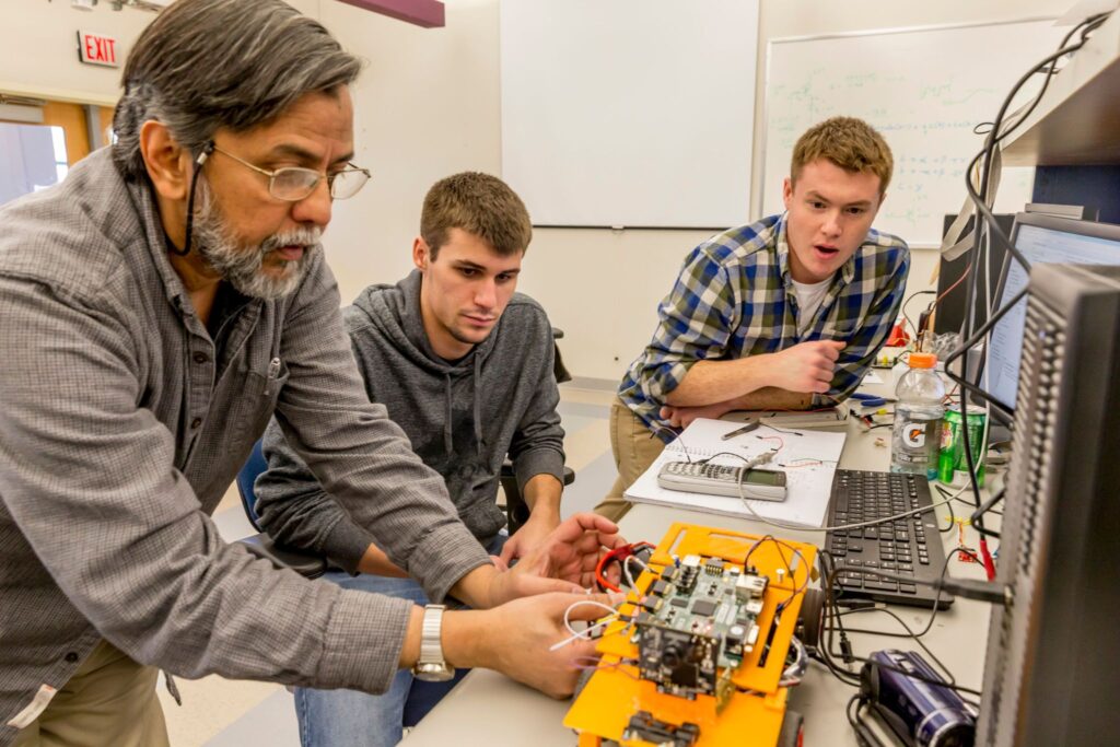 Two students and a professor test autonomous cars built for their senior project.