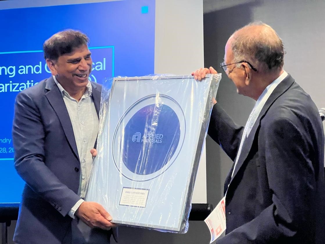 S.V. Babu receives a large plaque from Applied Materials’ Vice President, Nag Patibandla