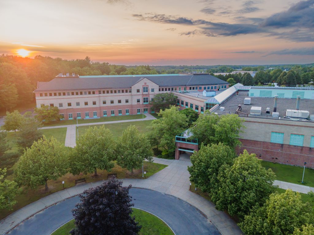 Aerial shot of Center for Advanced Materials Processing building at Clarkson University with a sunset in the background