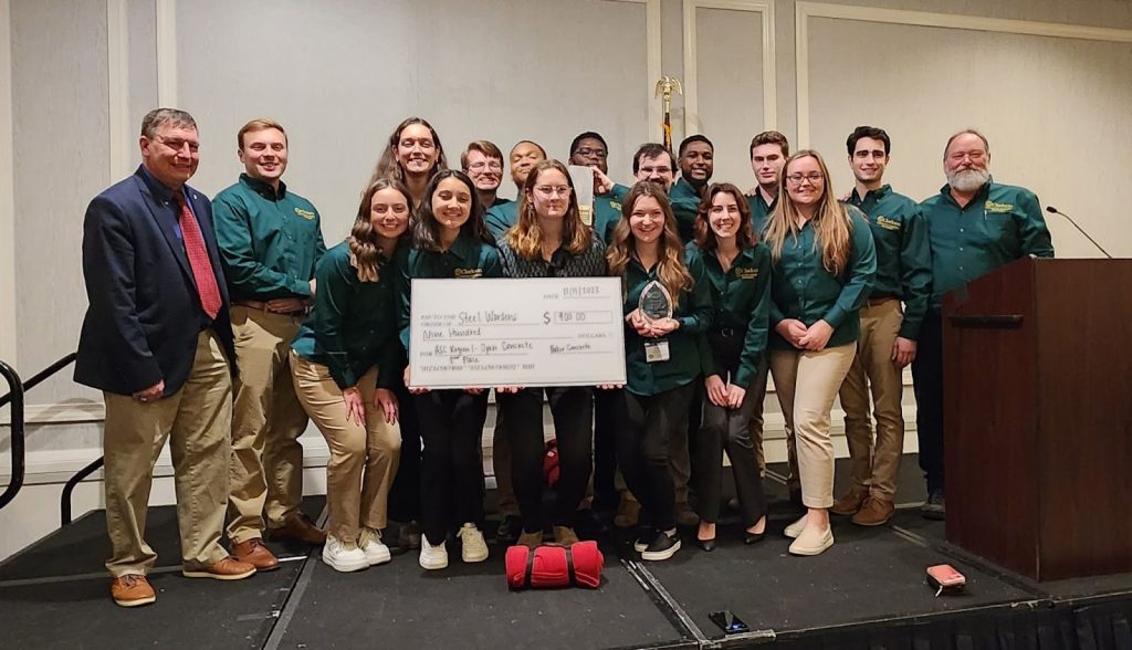 Students from Clarkson University’s Construction Engineering Management (CEM) Program, Student Projects in Engineering Experience and Design (SPEED) teams pose with prize money check