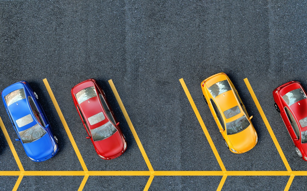 The image features cars parked in a parking lot.