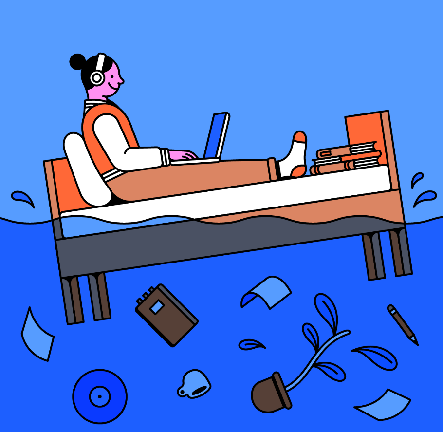 A person sitting on a bed with a laptop, engrossed in work while floating with their belongings in water