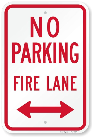 Sign. Red lettering on white. No parking. Fire Lane.
