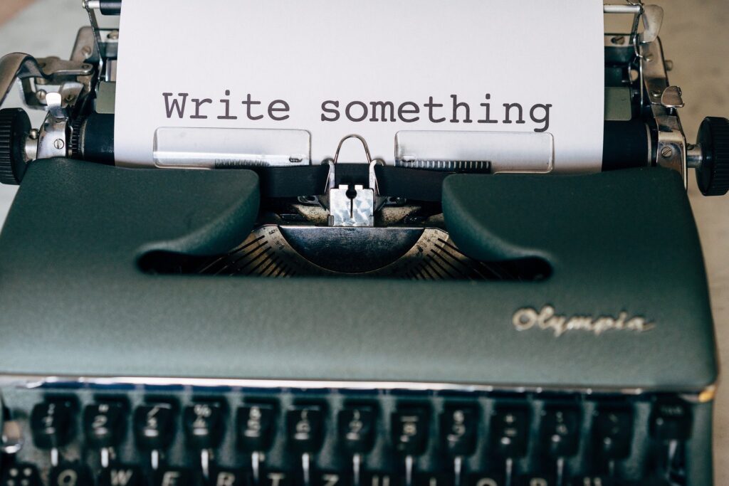 typewriter with 'write something' typed on the inserted paper.